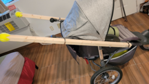 broken stroller repaired with wooden handles